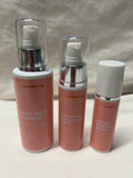 Three skincare bottles labeled 'Calm Milk Cleanse', 'Nourishing Moisturizer', and 'Hydra Bloom Serum' on a neutral background.