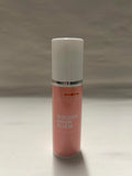 Pink bottle labeled 'Golden Hour Elixir' on a gray background