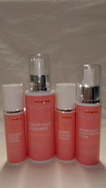Set of 4 skincare products with visible branding on a plain background